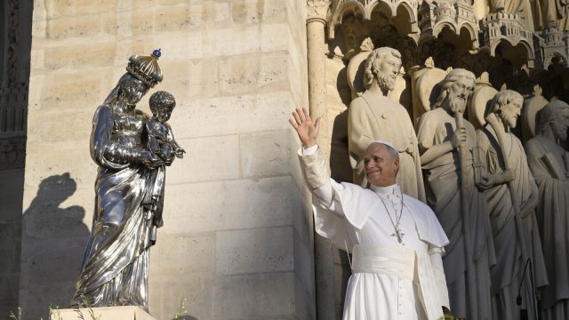 Pope Leo XIV in prayer before a silver statue of Our Lady and the Child Jesus outside Notre-Dame Cathedral in Paris