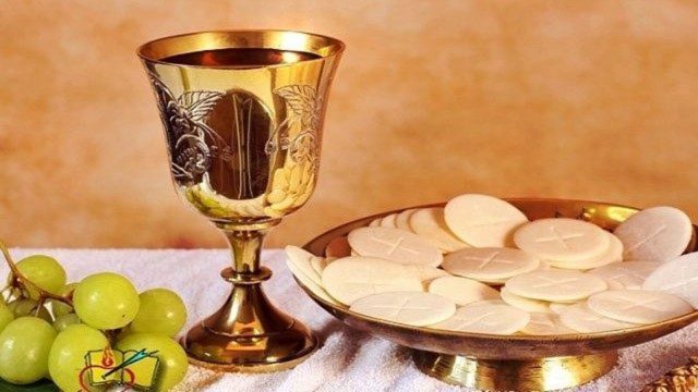 A child receiving Holy Communion from a priest during Mass