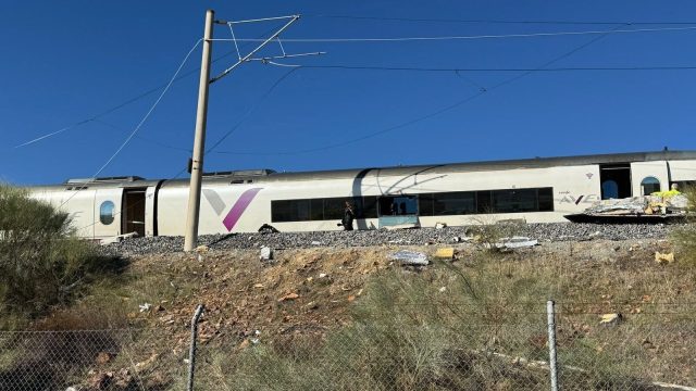 A priest stands amid the response to the train collision near Urda, in the province of Toledo