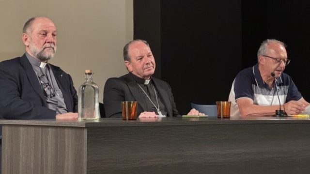 The two missionary bishops seated at a table during the panel discussion at the Aula San Pablo in Vitoria