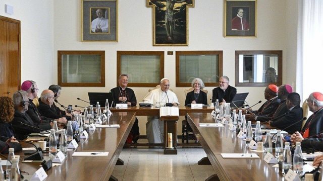 Lay men and women seated at round tables during a Synod assembly working session