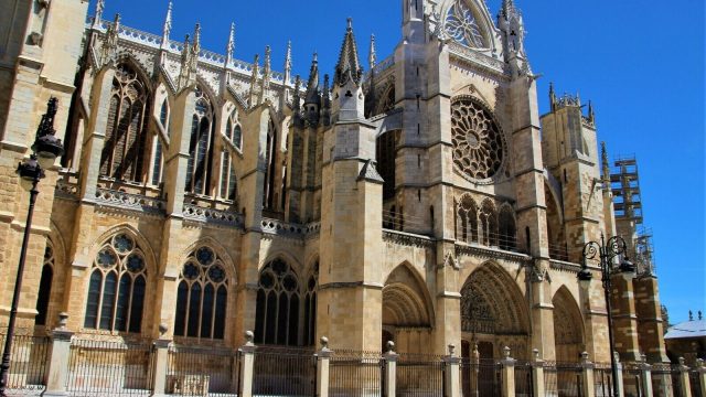The Gothic towers and stone facade of a Spanish cathedral rising above the rooftops of the surrounding city